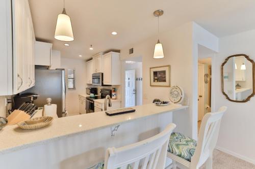 a kitchen and dining room with a counter and chairs at 2-2 Riverfront Condo At Bouchelle Island in New Smyrna Beach