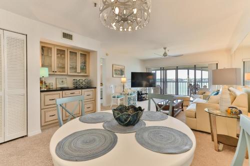 a kitchen and living room with a table and chairs at 2-2 Riverfront Condo At Bouchelle Island in New Smyrna Beach