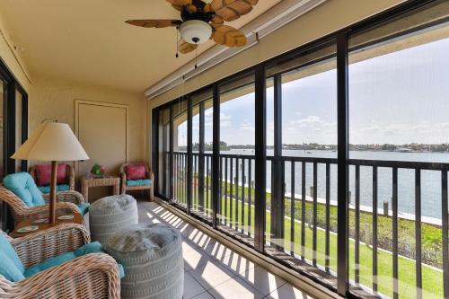 a screened in porch with a view of the water at 2-2 Riverfront Condo At Bouchelle Island in New Smyrna Beach