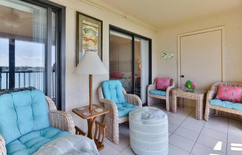 a living room with chairs and a table at 2-2 Riverfront Condo At Bouchelle Island in New Smyrna Beach