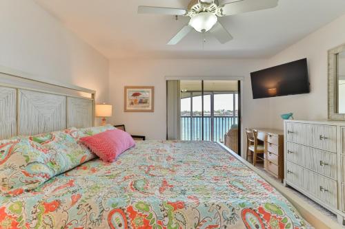 a bedroom with a bed and a ceiling fan at 2-2 Riverfront Condo At Bouchelle Island in New Smyrna Beach