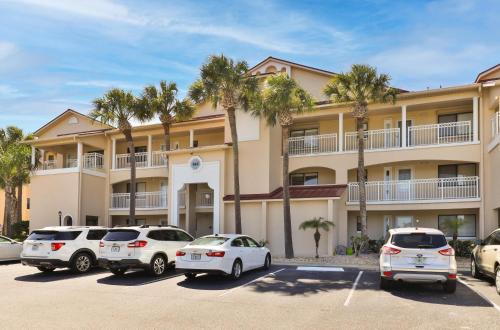 a parking lot in front of a building with palm trees at 2-2 Riverfront Condo At Bouchelle Island in New Smyrna Beach