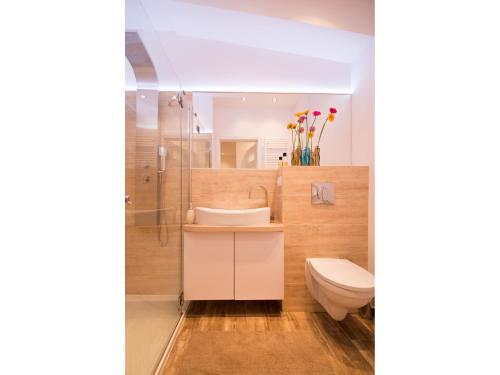 a bathroom with a sink and a toilet at Apartament Świętojańska in Gdańsk