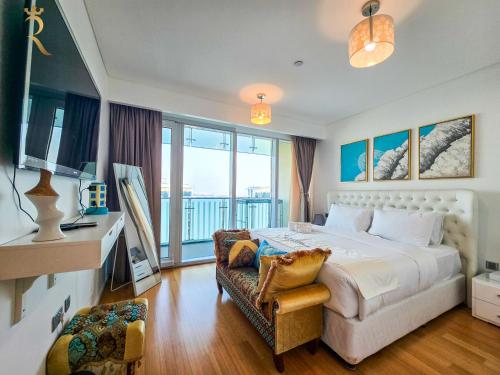 a bedroom with a large bed and a balcony at Al Raha Serenity - Spacious 2BR Getaway Near Yas Island & Al Raha Beach in Abu Dhabi