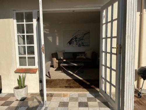 a living room with a couch and a table at Orchid on Main - Valley of 1000 hills in Drummond