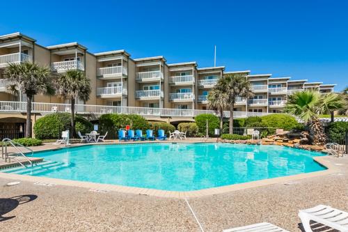a swimming pool in front of a apartment building at Victorian Condo #9227 in Galveston