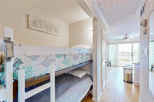 a bedroom with two bunk beds and a balcony at Victorian Condo #9227 in Galveston
