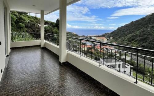 a balcony with a view of the mountains at Ribeira Roots Residence in Santa Cruz