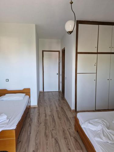 a room with two beds and a closet at Hotel Athina in Asprovalta