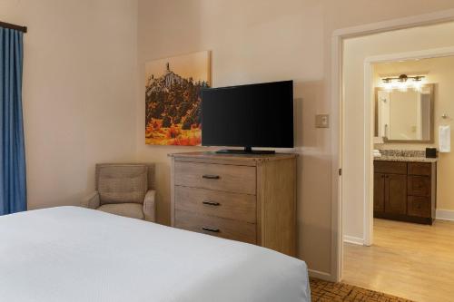 a bedroom with a bed and a television on a dresser at Club Wyndham Pagosa in Pagosa Springs