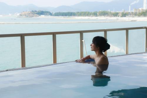 a young girl standing in a pool of water at Ako Onsen Shokichi in Ako