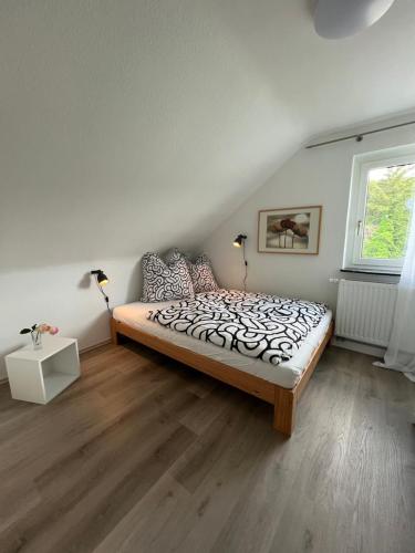 a bedroom with a bed and a window at Ferienhaus am Schorren in Bad Schussenried