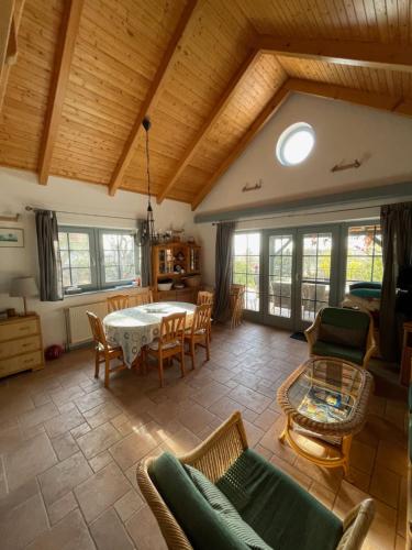 a living room with a table and chairs at Mandula House in Paloznak