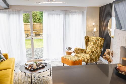 a living room with a yellow couch and chairs at Captivating 2-Bed House in Nettleham in Lincoln