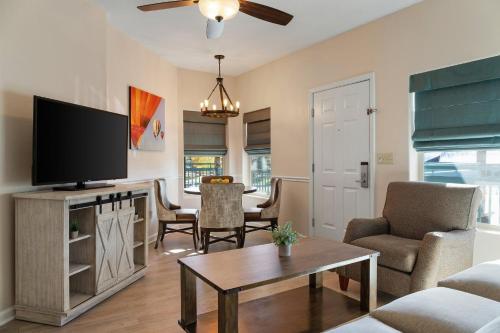 a living room with a television and a table at Club Wyndham Pagosa in Pagosa Springs