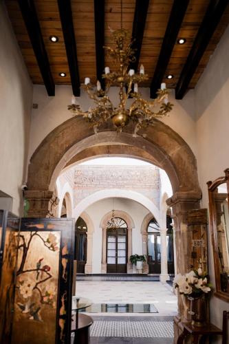 a large room with a chandelier in a building at Hotel Boutique Casona los Pavorreales in Durango