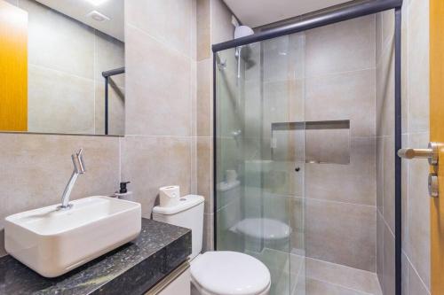 a bathroom with a toilet and a sink and a shower at Marina do Cupe 302 in Porto De Galinhas