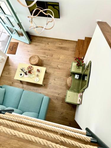 a living room with a blue couch and a table at Soul Apartments Mikulov in Mikulov