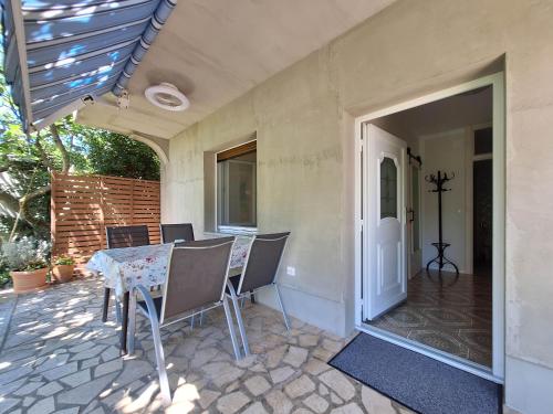 a patio with a table and chairs on a porch at Apartment Harmonia in Dramalj