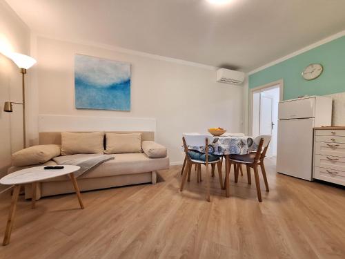 a living room with a couch and a table at Apartment Harmonia in Dramalj