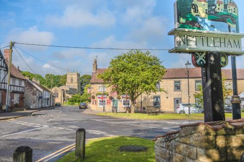a street in a small town with a street sign at Captivating 2-Bed House in Nettleham in Lincoln