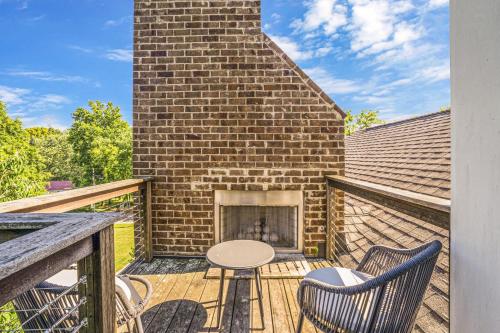a patio with two chairs and a table and a fireplace at Musician's Ranch in Franklin