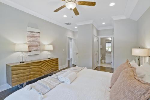 a bedroom with a white bed and a ceiling fan at Musician's Ranch in Franklin