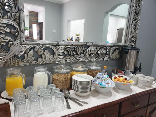 a counter with food on it with a mirror at 31 on Windsor Guest House in Durban