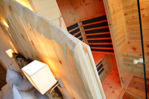 an overhead view of a room with a bed and a lamp at Chalet Elisabeth dolomites alpin & charme in Selva di Val Gardena