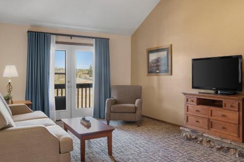 a living room with a television and a couch and chair at Club Wyndham Pagosa in Pagosa Springs