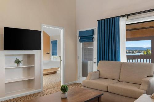 a living room with a couch and a tv and a window at Club Wyndham Pagosa in Pagosa Springs