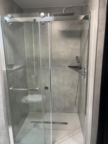 a shower with a glass door in a bathroom at Jungle suite romantic - private Jacuzzi - in Brussels