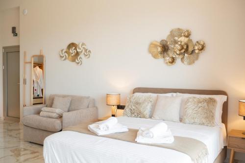 a bedroom with a bed with two towels on it at Petradi Suites in Kalamata