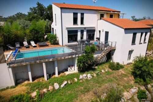 an aerial view of a house with a swimming pool at Villa contemporaine, jardin méditerranéen et piscine privée in Saint-Jean-Pla-de-Corts