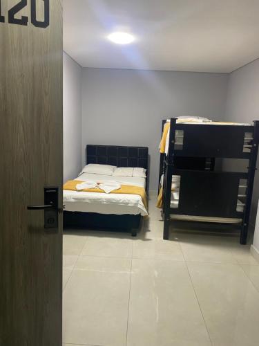 Postel nebo postele na pokoji v ubytování hotel escorial neiva