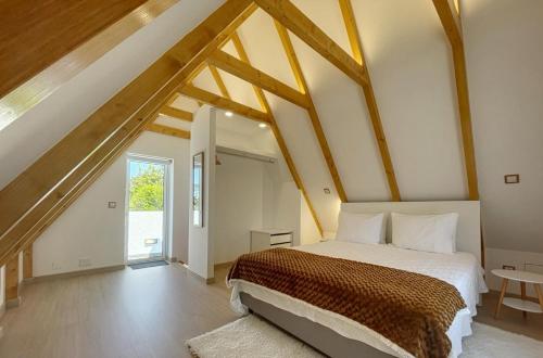 a bedroom with a large bed in a attic at Celeiro do Avô in Santana