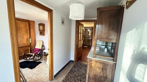 a hallway with a room with a mirror and a wheelchair at Casa de aldea A Cinza in Barreiros