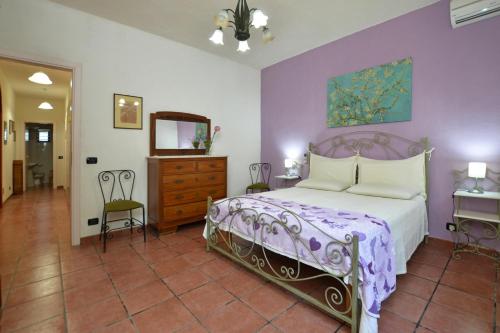 a bedroom with a bed and a dresser and a mirror at Villa Torres - Happy Rentals in Scicli
