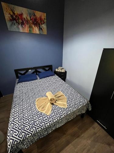 a bed with a black and white comforter with a bow on it at Recreo Verde Hot Springs & Spa in Marsella
