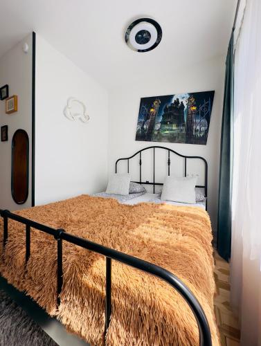 a bedroom with a large bed with a black frame at Very Bad Hootel in Kaunas