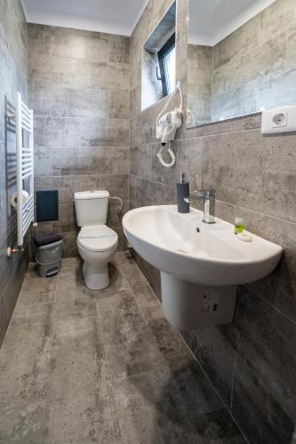 a bathroom with a sink and a toilet at Casa Mathias in Eforie Nord