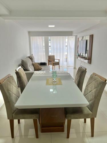a dining room with a white table and chairs at Apartamento luxuoso rua lazer in Domingos Martins
