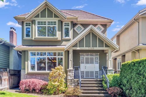 a house with a green at Cozy 1bedroom Suite in Vancouver Westside in Vancouver