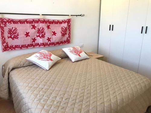 a bedroom with a bed with two pillows on it at Gabbiano house in Murta Maria