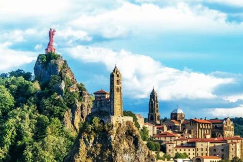 a city on top of a mountain with a town at appartement rénové-équipé en centre-ville in Le Puy en Velay