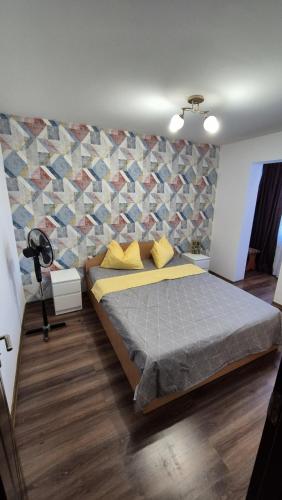 a bedroom with a large bed with a wall at Mike Rent Apt in Baia Mare