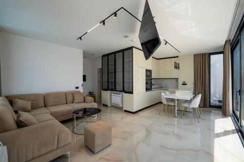 a living room with a couch and a table at Luxury Villas Angela in Ksamil