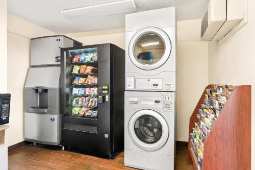 a laundry room with a refrigerator and a washer at Red Roof Inn Allentown Airport in Allentown