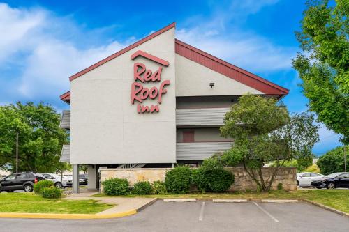 a building with a red roof with a sign on it at Red Roof Inn Allentown Airport in Allentown