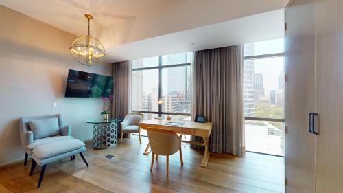 a living room with a table and a chair at Hotel Marquis Reforma in Mexico City